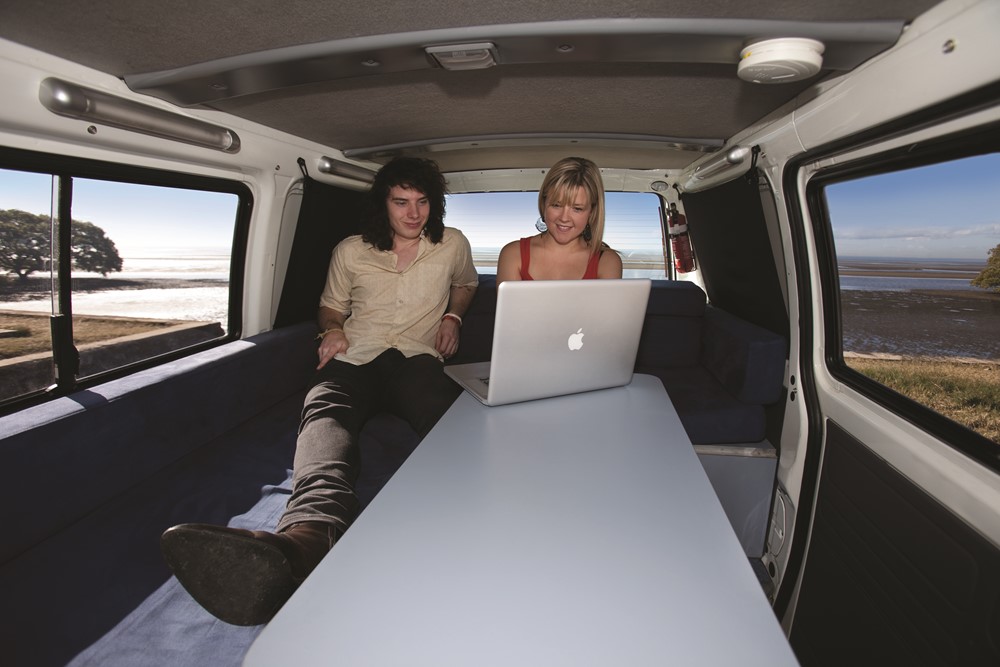 Couple with a Laptop- Adelaide Hills campervan hire - Campervan Rental Shop